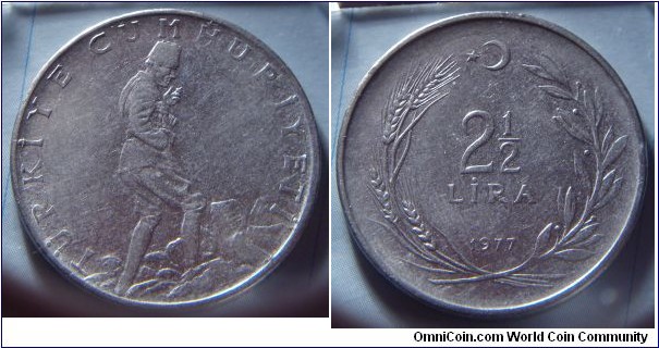 Turkey |
2½ Lira, 1977 |
30 mm, 9 gr. |
Stainless Steel |

Obverse: Man wearing hat walking up rocky landscape |
Lettering: TÜRKİYE CUMHURİYETİ |

Reverse: Denomination inside wreath of wheat stalk and olive sprig, star and rescent above, date below |
Lettering: 2½ LİRA 1977 |