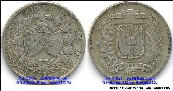 1869 Swiss Federal Shooting Festival Thaler 5 Francs Silver Coin, Inscription: Obverse: EIDGENOSSISCHES SCHUTZENFEST 1869 IN ZUG., 5 Fr. (Translation: Federal shooting festival 1869 in Zug – 5 francs), Reverse: DIOS, PATRIA, LIBERTAD( The Dominican republic national motto: Freedom, God, Homeland ), REPUBLICA DOMINICANA (The Dominican republic)