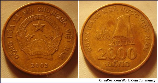 Vietnam | 
2,000 Đồng, 2003 | 
23.92 mm, 5 gr. | 
Brass plated Steel | 

Obverse: National Coat of Arms, date below | 
Lettering: CỘNG HÒA XÃ HỘI CHỦ NGHĨA VIỆT NAM 2003 | 

Reverse: Ethnic house, denomination below | 
Lettering: NGÂN HÀNG NHÀ NƯỚC VIỆT NAM 2000 ÐỒNG |