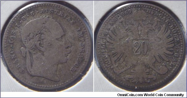 Austria-Hungary | 
20 Kreuzer, 1869 | 
21 mm, 2.67 gr. | 
Silver (.500) | 

Obverse: Emperor Franz Joseph I./I. Ferenc József facing right | 
Lettering: FRANC • IOS • I • D • G • AVSTRIAE IMPERATOR | 

Reverse: Double-headed eagle, symbolizing the Austro-Hungarian Empire, denomination in middle, date upper left | 
Lettering: HVNGAR • BOHEM • GAL• LOD • ILL • REX A • A • 1869 |