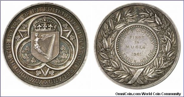 1881 UK Irish Intermediate Education Board Medal. Silver 51MM./88.63 gms.
Obv: Harp formed by a winged women with Irish symbol. Legend AWARDED BY THE BOARD OF INTERMEDIATE EDUCATION TRELAND. Obv: Inscription GEORGE.F.COURTENAY FIRST IN MUSIC 1881 SENIOR GRADE. Wreath surrounded.
