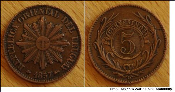 Uruguay | 
5 Centésimos, 1857 | 
23.2 mm, 4.5 gr. | 
Copper | 

Obverse: Sun with rays, date below | 
Lettering: REPUBLICA ORIENTAL DEL URUGUAY | 

Reverse: Laurel wreath, denomintaion above| 
Lettering: CENTESIMOS 5 D |