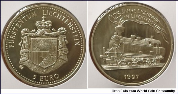 Liechtenstein | 
5 Euro, 1997 – 125 Year of Liechtenstein Railroads | 
38.61 mm, 28 gr. | 
Copper-nickel | 

Obverse: National Coat of Arms, denomination below | 
Lettering: FÜRSTENTUM LIECHTENSTEIN 5 RUEO | 

Reverse: Locomotive, date below | 
Lettering: 125 JAHRE EISENBAHN IN LIECHTENSTEIN 1997 |