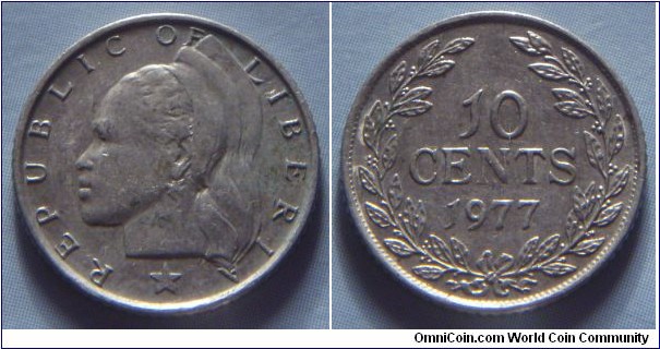 Liberia | 
10 Cents, 1977 | 
16.5 mm, 1.8 gr. | 
Copper-nickel | 

Obverse: Native girls facing left | 
Lettering: * REPUBLIC OF LIBERIA | 

Reverse: Denomination, date below | 
Lettering: 10 CENTS 1977 |