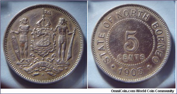 North Borneo | 
5 Cents, 1903 | 
28.1 mm, 7.3 gr. | 
Copper-nickel | 

Obverse: Coat of Arms with supporters | 

Reverse: Denomination, date below | 
Lettering: • STATE OF NORTH BORNEO • 1903 |
