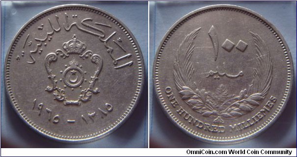 Kingdom of Libya | 
100 Millièmes, 1965 (1385) | 
30 mm, 11 gr. | 
Copper-nickel | 

Obverse: National Coat of Arms, date below | 
Lettering: المملكة الليبية ١٩٦٥–١٣٨٥ | 

Reverse: Denomination within wreath | 
Lettering: ١٠٠ مليم ONE HUNDRED MILLIÈMES |