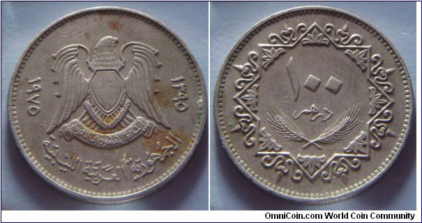 Libya Arab Republic | 
100 Dirham, 1975 (1395) | 
27 mm, 8.1 gr. | 
Copper-nickel | 

Obverse: National Coat of Arms, date to the right and left | 
Lettering: ١٩٧٥ ١٣٩٥ الجمهورية العربية الليبية | 

Reverse: Denomination | 
Lettering: ١٠٠ درهم |