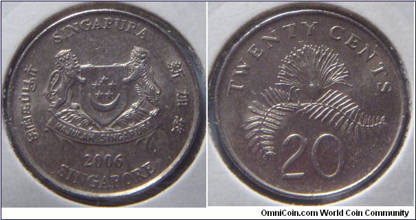 Singapore | 
20 Cent, 2006 | 
21.36 mm, 4.5 gr. | 
Copper-nickel | 

Obverse: National Coat of Arms with ribbons downwards, date below | 
Lettering: சிங்கப்பூர் SINGAPURA 新加坡 SINGAPORE 2006 | 

Reverse: Powder-puff Plant, denomination below | 
Lettering: TWENTY CENTS 20 |
