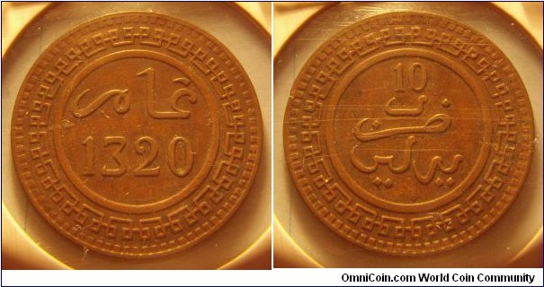 Morocco | 
10 Mazunas, 1903 (1320) | 
30 mm, 10 gr. | 
Bronze | 

Obverse: Date | 
Lettering: عام 1320 | 

Reverse: Mint name, denomination above | 
Lettering: 10ضرب برلين |