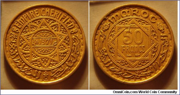 French Morocco | 
50 Francs, 1952 (1371) | 
27 mm, 7.9 gr. | 
Aluminium-bronze | 

Obverse: Date | 
Lettering: * EMPIRE CHERIFIEN * عام 1371 الدولة المغربية * فرنكات  |

Reverse: Denomination in centre | 
Lettering: MAROC 50 FRANCS السكة المحمدية الشريفة |