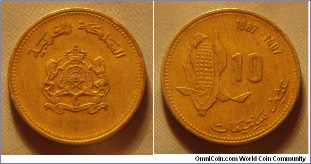 Morocco | 
10 Santimat, 1987 (1407) – FAO | 
20 mm, 3 gr. | 
Aluminium-bronze | 

Obverse: National Coat of Arms | 
Lettering: المملكة المغربية |

Reverse: Single ear of corn, denomination right, date above | 
Lettering: 10 1987 – 1407 عشر سنتيمات |
