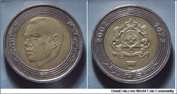 Morocco | 
5 Dirhams, 2002 (1423) | 
25 mm, 7.5 gr. | 
Bi-metallic: Brass centre in Copper-nickel ring | 

Obverse: King Hassan VI facing left | 
Lettering: محمد السادس المملكة المغربية |

Reverse: National Coat of Arms, date left and right, denomination below | 
Lettering: 2002 1423 خمسة 5 دراهم |