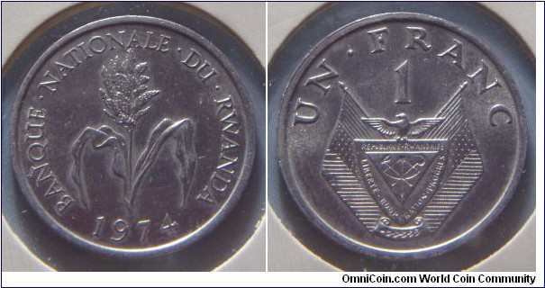Rwanda | 
1 Franc, 1974 | 
22 mm, 1.06 gr. | 
Aluminum | 

Obverse: Plant, date below | 
Lettering: BANQUE • NATIONALE • DU • RWANDA 1974 | 

Reverse: National Coat of Arms, denomination above | 
Lettering: UN • FRANC 1 |