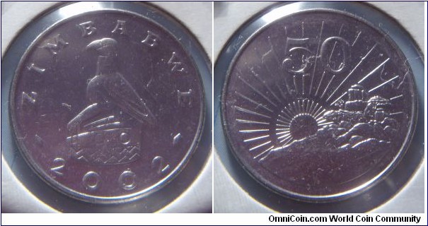 Zimbabwe | 
50 Cents, 2002 | 
26 mm, 7.5 gr. | 
Nickel plated Steel | 

Obverse: National Coat of Arms, date below | 
Lettering: ZIMBABWE 2002 | 

Reverse: Radiant sun rising (symbolic of independence), denomination above | 
Lettering: 50 |