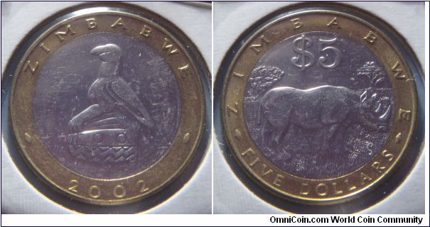 Zimbabwe | 
5 Dollars, 2002 | 
27.4 mm, 9.05 gr. | 
Bi-Metallic: Nickel plated Steel centre in Brass ring | 

Obverse: National Coat of Arms, date below | 
Lettering: ZIMBABWE 2002 | 

Reverse: Rhinoceros facing right, denomination above | 
Lettering: ZIMBABWE FIVE DOLLARS $5 |