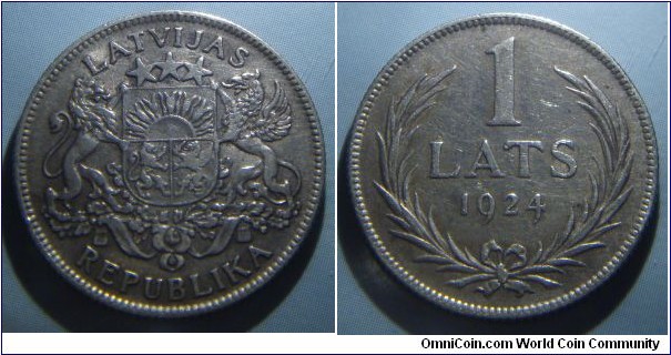 Latvia | 
1 Lats, 1924 | 
23 mm, 5 gr. | 
Silver (.835) | 

Obverse: National Coat of Arms | 
Lettering: LATVIJAS REPUBLIKA | 

Reverse: Denomination and date within wreath | 
Lettering: 1 LATS 1924 |