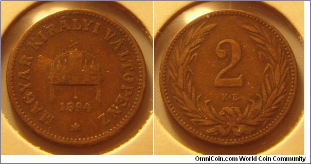 Kingdom of Hungary | 
2 Fillér, 1894 | 
19 mm, 4 gr. | 
Bronze | 

Obverse: Crown with crooked cross, date below | 
Lettering: * MAGYAR KIRÁLYI VÁLTÓPÉNZ 1894 | 

Reverse: Denomination within wreath | 
Lettering: 2 |