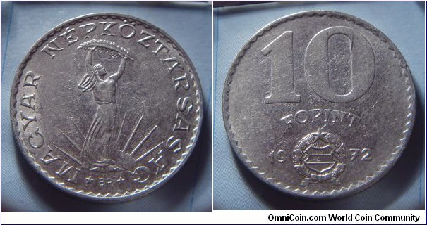 Hungarian People's Republic | 
10 Forint, 1972 | 
28 mm, 8.83 gr. | 
Nickel | 

Obverse: Strobl monument: Woman holding up frond with both hands, wun with rays behind | 
Lettering: * MAGYAR NÉPKÖZTÁRSASÁG * | 

Reverse: Denomination, National Coat of Arms divides date below | 
Lettering: 10 FORINT 1972 |