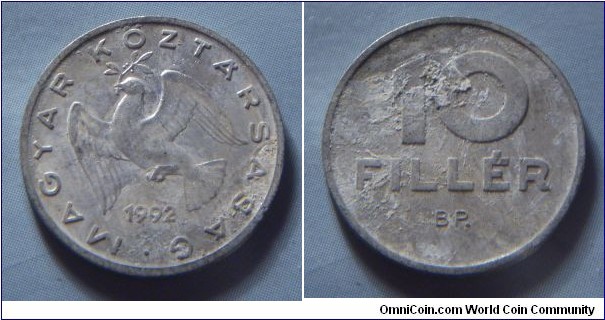 Hungary | 
10 Fillér, 1992 | 
18.5 mm, 0.6 gr. | 
Aluminium | 

Obverse: Dove flying with sprig in beak, date below | 
Lettering: • MAGYAR KÖZTÁRSASÁG 1992 | 

Reverse: Denomination | 
Lettering: 10 FILLÉR |