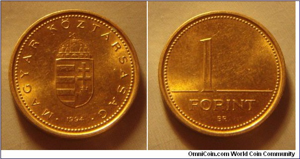 Hungary | 
1 Forint, 1994 | 
16.3 mm, 2.05 gr. | 
Nickel-brass | 

Obverse: National Coat of Arms, date below | 
Lettering: • MAGYAR KÖZTÁRSASÁG • 1994 | 

Reverse: Denomination | 
Lettering: 1 FORINT |