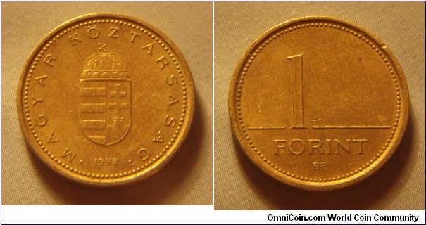 Hungary | 
1 Forint, 1998 | 
16.3 mm, 2.05 gr. | 
Nickel-brass | 

Obverse: National Coat of Arms, date below | 
Lettering: • MAGYAR KÖZTÁRSASÁG • 1998 | 

Reverse: Denomination | 
Lettering: 1 FORINT |