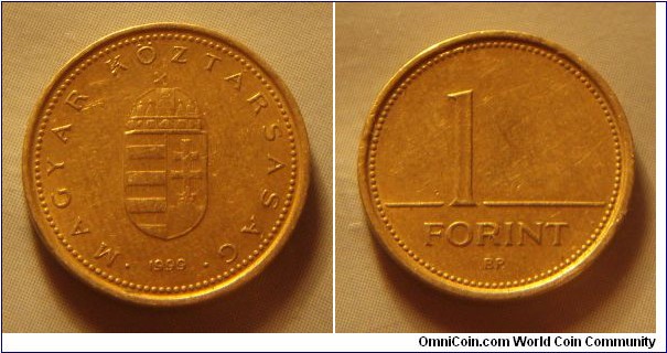 Hungary | 
1 Forint, 1999 | 
16.3 mm, 2.05 gr. | 
Nickel-brass | 

Obverse: National Coat of Arms, date below | 
Lettering: • MAGYAR KÖZTÁRSASÁG • 1999 | 

Reverse: Denomination | 
Lettering: 1 FORINT |