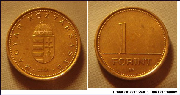 Hungary | 
1 Forint, 2000 | 
16.3 mm, 2.05 gr. | 
Nickel-brass | 

Obverse: National Coat of Arms, date below | 
Lettering: • MAGYAR KÖZTÁRSASÁG • 2000 | 

Reverse: Denomination | 
Lettering: 1 FORINT |