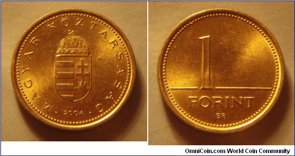 Hungary | 
1 Forint, 2004 | 
16.3 mm, 2.05 gr. | 
Nickel-brass | 

Obverse: National Coat of Arms, date below | 
Lettering: • MAGYAR KÖZTÁRSASÁG • 2004 | 

Reverse: Denomination | 
Lettering: 1 FORINT |