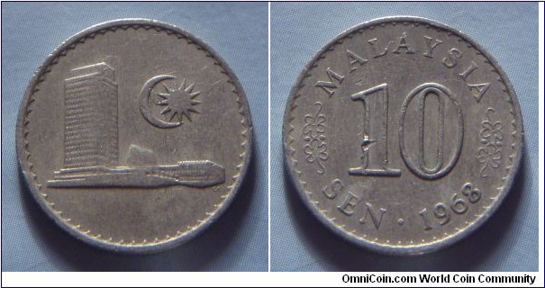 Malaysia | 
10 Sen, 1968 | 
19.4 mm, 2.82 gr. | 
Copper-nickel | 

Obverse: Parliament building, moon crescent and a 13-pointed star right | 

Reverse: Denomination, date below | 
Lettering: MALAYSIA 10 SEN • 1968 |