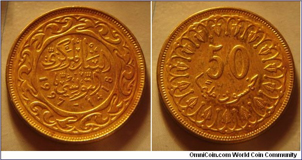 Tunisia | 
50 Millimes, 1997 | 
25 mm, 6 gr. | 
Brass | 

Obverse: Date | 
Lettering: البنك المركزي التونسي 1997-1418 |

Reverse: Denomination | 
Lettering: 50 خمسون مليما |