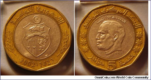 Tunisia | 
5 Dinars, 2002 - 2nd Anniversary of Demise of Habib Bourguiba | 
29 mm, 10 gr. | 
Bi-metallic: Copper-nickel centre in Brass ring | 

Reverse: National Coat of Arms, date below | 
Lettering: 2002-1423 الجمهورية التونسية |

Obverse: Habib Bourguiba facing left, date below | 
Lettering: البنك المركزي التونسي الحبيب بورقيبة 2000-1903 خمسة 5 دنانير |