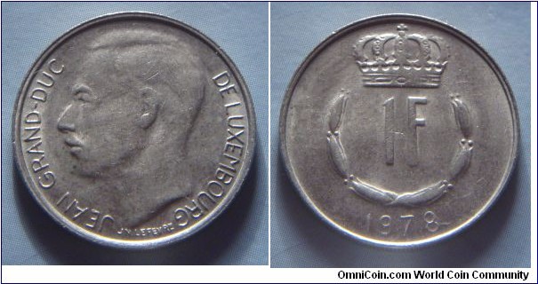 Luxembourg | 
1 Franc, 1978 | 
21 mm, 4 gr. | 
Copper-nickel | 

Obverse: Adolphe, Grand Duke of Luxembourg facing right | 
Lettering: JEAN GRAND-DUC DE LUXEMBOURG |

Reverse: Crowned  upturned horseshoe shaped of six flower buds surrounds denomination, date below | 
Lettering: 1F 1978 |