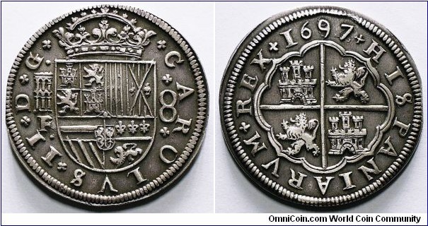 Charles II, 8 Reales, 1697/82. 26.8g, 40.67mm, 93.06% Silver. Segovia mint. Obverse: Crowned Spanish shield, Portugal shield removed. Reverse: Arms of Castile and Leon. Assayer: F (Francisco Pedrera and Negrete) on M. Mint mark: Aqueduct. Cy# 7685, Dav. #4416, KM# 227.