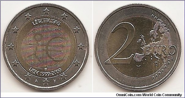 2 Euro
KM#107
8.5000 g., Bi-Metallic Nickel-Brass center in Copper-Nickel ring, 25.75 mm. Subject : Ten years of Economic and Monetary Union(EMU). Obv: The inner part of the coin shows a stylised human figure whose left arm is prolonged by the euro symbol. The initials ΓΣ of the sculptor appear below the euro symbol. The name of the issuing country in the national language appear at the top LËTZEBUERG while the acronym EMU translated into the national language appear at the bottom UEM 1999-2009. Due to special laws requiring that every coin bear the incumbent Grand Duke's portrait, the Luxembourgish edition of the common €2 commemorative coin differs slightly from the others in addition to the translated inscriptions, since two latent image of the Grand Duke's portrait were added (as required by national law). The method used (multi-view-minting) was even more sophisticated than the one used in 2007, as portraits of the Grand Duke from the left and the right could be seen, depending on which way one tilted the coin. The twelve stars of the European Union surround the design on the outer ring of the coin. The mint marks on both sides of 6 h star. Rev: 2 on the left-hand side, six straight lines run vertically between the lower and upper right-hand side of the face, 12 stars are superimposed on these lines, one just before the two ends of each line, superimposed on the mid - and upper section of these lines; the European continent ( extended ) is represented on the right-hand side of the face; the right-hand part of the representation is superimposed on the mid-section of the lines; the word ‘EURO’ is superimposed horizontally across the middle of the right-hand side of the face. Under the ‘O’ of EURO, the initials ‘LL’ of the engraver appear near the right-hand edge of the coin. Edge: Reeded with 2 * *, repeated six times, alternately upright and inverted. Obv. designer: Georgios Stamatopoulos Rev. designer: Luc Luycx