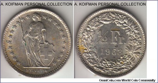 KM-23, 1963 Switzerland 1/2 franc; silver, reeded edge; average uncirculated, a yellow spot on reverse is much less prominent.