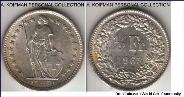 KM-23, 1963 Switzerland 1/2 franc; silver, reeded edge; average uncirculated, a yellow spot on reverse is much less prominent.