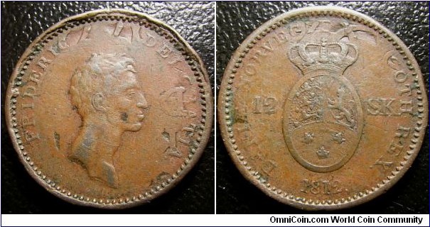 Denmark 1812 12 skilling overstruck over 1771 1 skilling. The coin seems to be cut. Weight: 10.39g. 