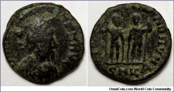 Honorius, Cyzicus, AE3. DN HONORIVS PF AVG, pearl-diademed, draped, cuirassed bust right / GLORIA ROMANORVM, Two emperors standing facing, heads turned to one another, each holding spear and resting hand on shield. The emperor on the right is smaller than the other. Mintmark SMKA.