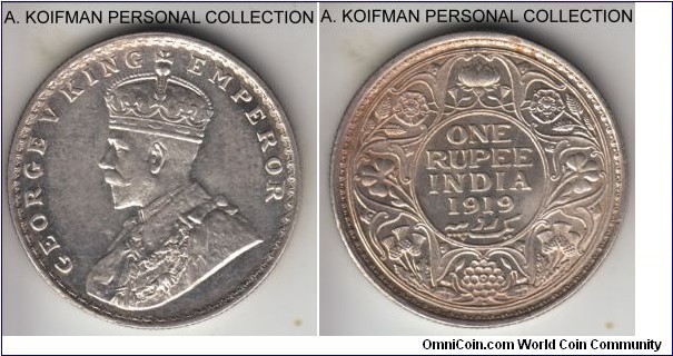 KM-524, 1919 (b) British India rupee, Bombay mint (dot mint mark on reverse); silver, reeded edge; uncirculated - no signs of wear on any of the raised details - but interesting clatter in the fields, done most likley by the usted and cleaned obverse die, resulting in 