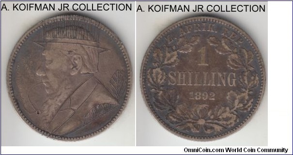 KM-5, 1892 Zuid-Afrikkansche Republiek (ZAR) South Africa shilling; silver, reeded edge; Boer war trench art or imitation, Krueger had a customary top hat and his pipe added, dark toned uncleaned very fine host coin.