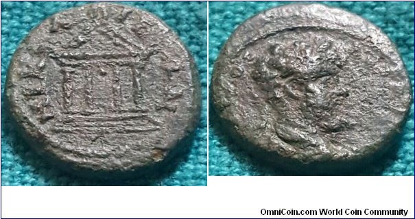 Septimius Severus .Ae15 of Nicaea Bithynia. NIK-A-IE-ON Tetrastyle Temple with pellet in centre. Laureate head R.