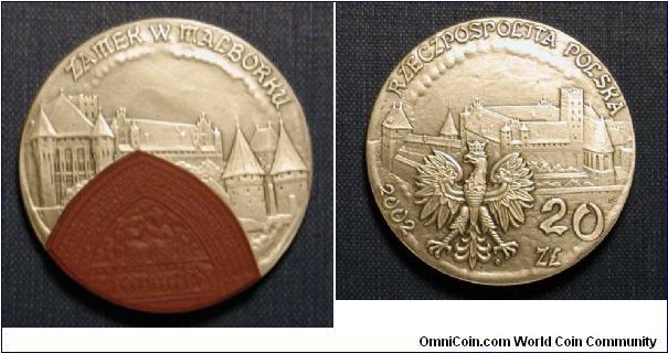 2002 Poland 20 Zloty, Castle Malbork Commemorative, is actual legal tender.  Silver and Ceramic.

Mintage: 50,001
