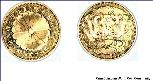 Japanese gold 100,000 yen of Emperor Hirohito for his 60th year of reign. The obverse design is a chrysanthemum.