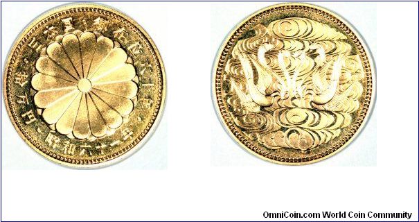 Japanese gold 100,000 yen of Emperor Hirohito for his 60th year of reign. The obverse design is a chrysanthemum.