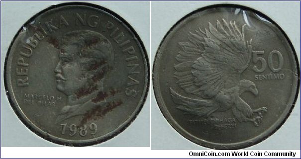 A 1989 50 Sentimo coin from the Pillippines looks like it spent some time in a vice
