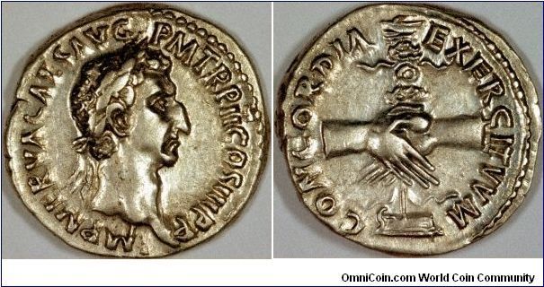 Born in the Etruscan town of Narnia on November 8th, 35 AD, one would expect to there should be chronicles of Nerva's life and times!
The silver denarius we have shown can be dated to 98 AD, the last year of his reign, by the obverse legend ...TR P II COS III...
The reverse shows clasped hands in front of a legionary standard, and the legend CONCORDIA EXERCITUUM (in agreement with the army).