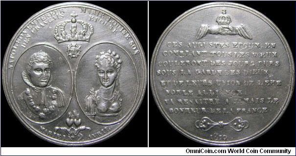 Mariage à Paris avec Marie-Louise, France.

A very rare white metal medal with unusual portraits. The reverse translates roughly to 'These august consorts, crowning all wishes, will spend peaceful days beneath the protection of the gods, and from their union, — from their glorious alliance, the happiness of France will flourish anew and for ever.'                                                                                                                                                     