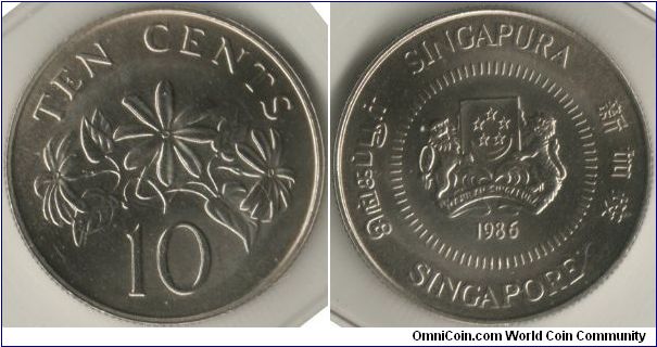 Singapore 1986 10 cents. Metal: Cupro-Nickel, 2.60g, 18.50mm. Featuring the Arms of Republic of Singapore with the year 1986 with 4 official languages around the circumference of the coins with additional ring of dashes around the arms. It also features Star Jasmine or goes by the scientific name Jasminum multiflorum.