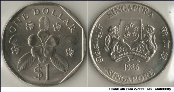Singapore 1986 1 dollar TRIAL. Metal: Cupro-Nickel, 9.97g, 26.50mm. Featuring the Arms of Republic of Singapore with the year 1986 with 4 official languages around the circumference of the coins. It also features periwinkle (another poisonous plant found quite common) or bettern known as Lochnera rosea. 

The reason why this is considered as trial as this never got circulated to the public. The final design of 1 dollar coin that got released is a smaller design and is in Al-Bronze.