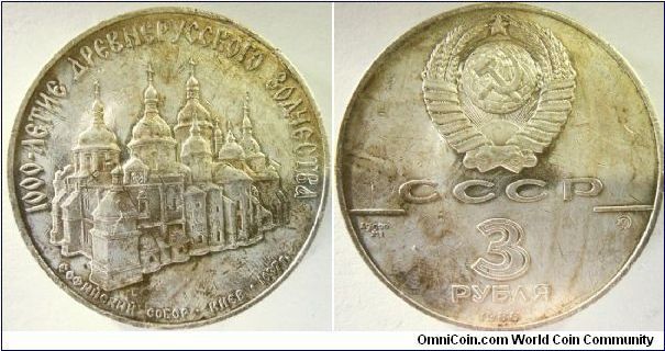 Russia 1988 3 rubles. 1000 years of Russian Christianity, featuring St. Sofia Cathedral in Kiev. 

Yes, this is supposed to be a proof coin in the first place, but for some reason, probably a kid took this coin from his dad's collection and decided to ruin it. :(